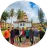 A circular photo of a group of people gathered outdoors in a public area.